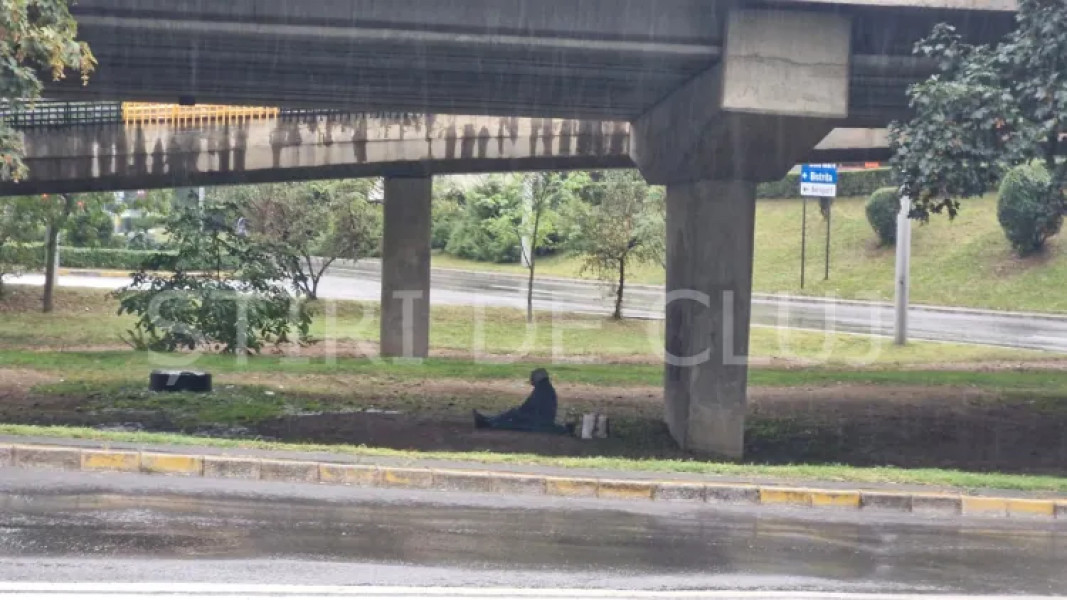 Om al străzii surprins sub un pod din Mărăști, Cluj-Napoca, încercând să se adăpostească de ploaie